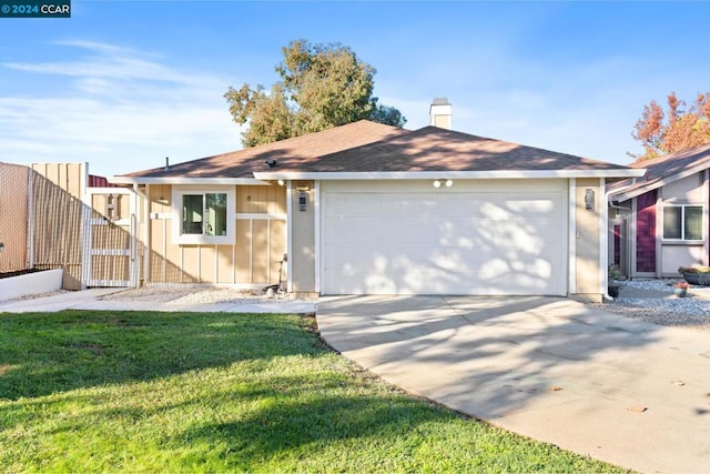 ranch-style house with a garage and a front yard