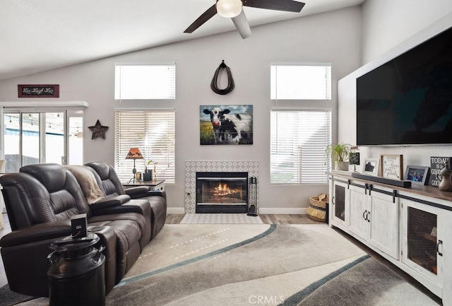 living room featuring light hardwood / wood-style flooring, plenty of natural light, and lofted ceiling