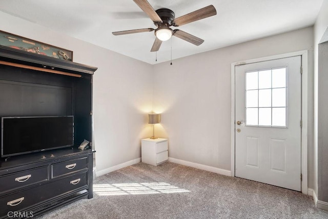 interior space featuring light carpet and ceiling fan