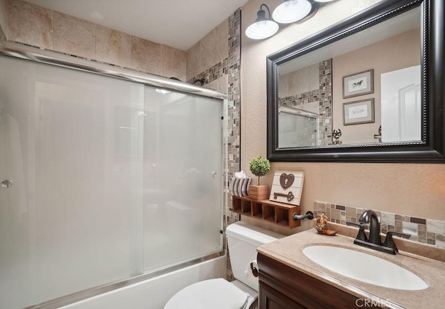 full bathroom with vanity, backsplash, toilet, and enclosed tub / shower combo