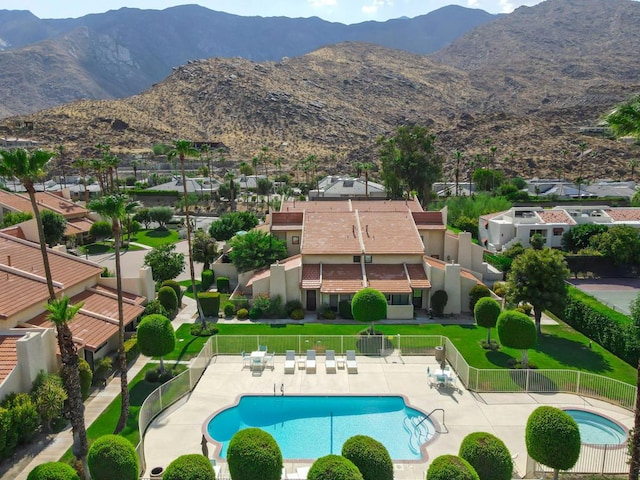 view of swimming pool with a mountain view and a patio area