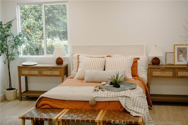 bedroom featuring baseboards and wood finished floors