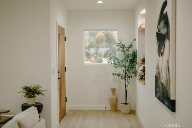 hallway with baseboards and recessed lighting
