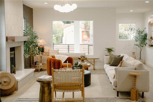 interior space featuring recessed lighting, a notable chandelier, and a tiled fireplace