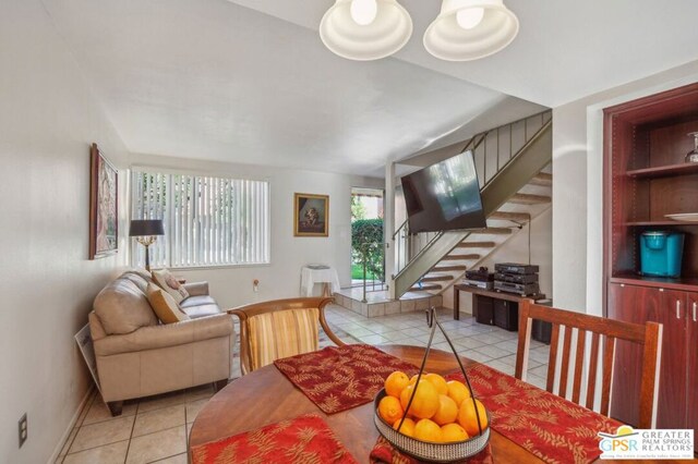 tiled living room featuring a chandelier