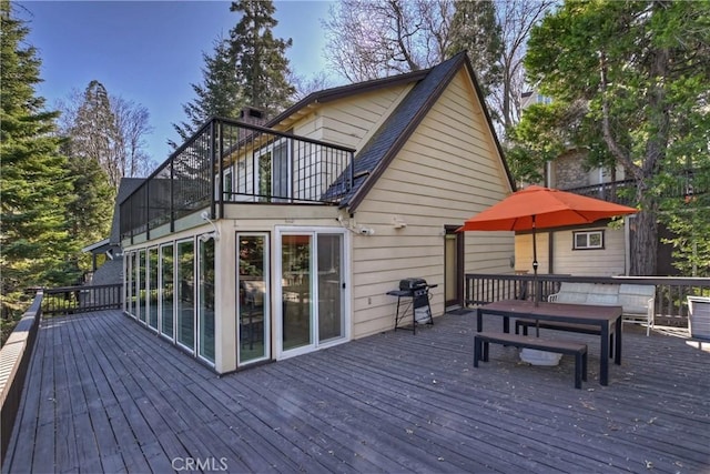 wooden terrace with a grill