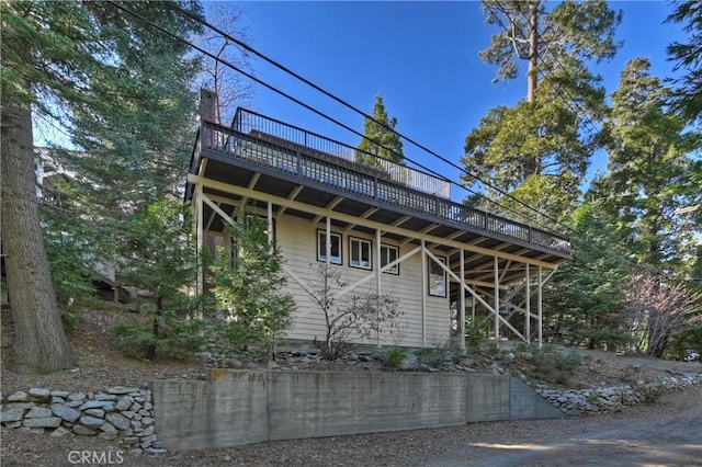 view of side of home with a wooden deck