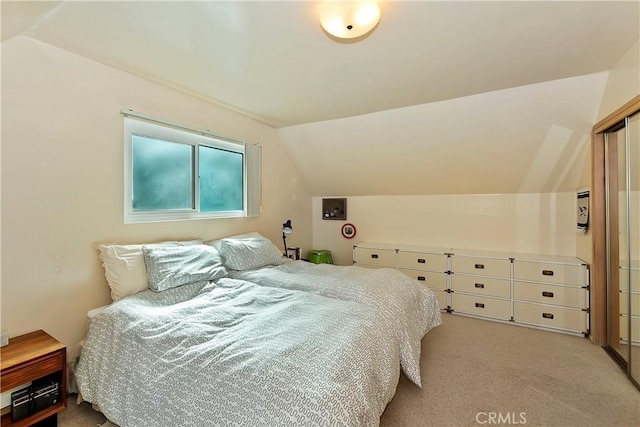 carpeted bedroom featuring vaulted ceiling