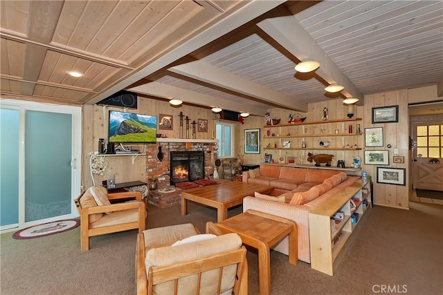 carpeted living room with wood walls and a brick fireplace