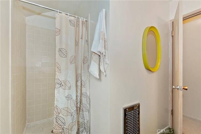 bathroom featuring heating unit and walk in shower