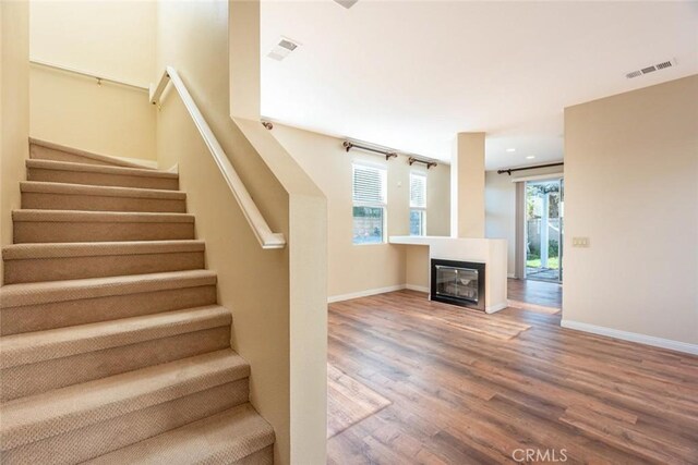 stairs with hardwood / wood-style flooring