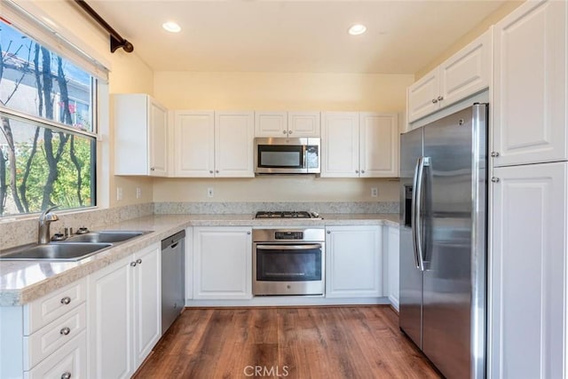 kitchen with sink, white cabinets, and appliances with stainless steel finishes