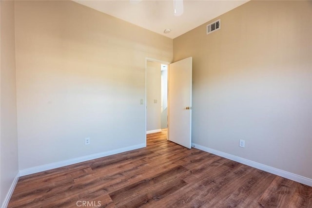 unfurnished room with dark hardwood / wood-style flooring