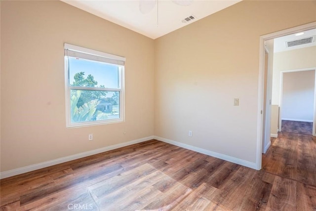 empty room with ceiling fan and hardwood / wood-style flooring