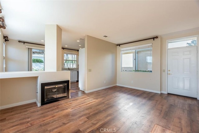 unfurnished living room with dark hardwood / wood-style flooring