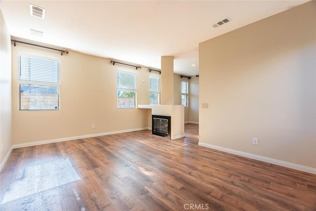 unfurnished living room featuring wood-type flooring