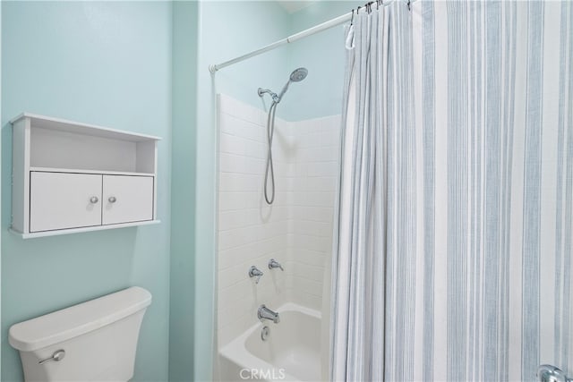 bathroom with toilet and shower / bath combo with shower curtain