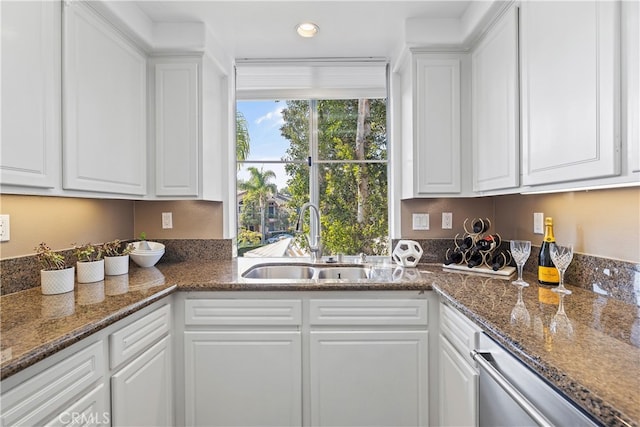 kitchen featuring sink and white cabinets