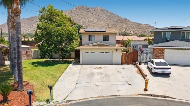 145 Carlota Way, Riverside, CA 92507 - view of front of house with driveway, solar panels, a mountain view, a garage, and stucco siding