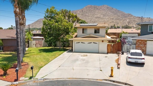 145 Carlota Way, Riverside, CA 92507 - view of front of property featuring concrete driveway, a mountain view, roof mounted solar panels, and stucco siding