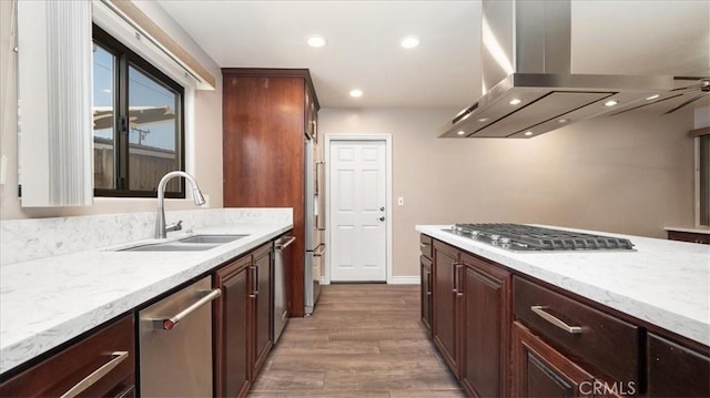 145 Carlota Way, Riverside, CA 92507 - kitchen with stainless steel appliances, island exhaust hood, wood finished floors, light stone countertops, and recessed lighting