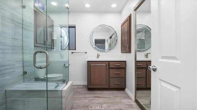 145 Carlota Way, Riverside, CA 92507 - bathroom featuring vanity, wood finished floors, a stall shower, and recessed lighting