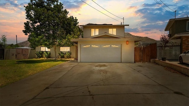 145 Carlota Way, Riverside, CA 92507 - traditional-style house with driveway, stucco siding, and a garage