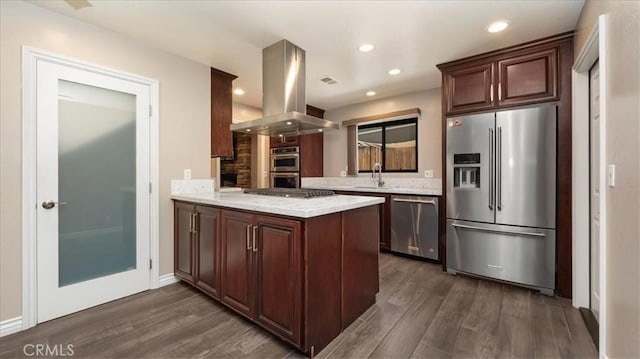 145 Carlota Way, Riverside, CA 92507 - kitchen with stainless steel appliances, island exhaust hood, dark wood-style floors, a peninsula, and recessed lighting