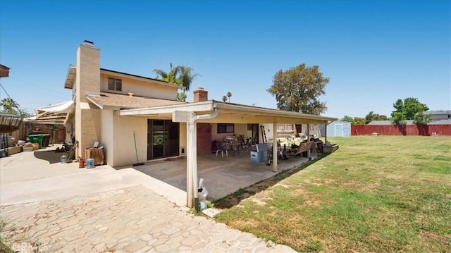 145 Carlota Way, Riverside, CA 92507 - rear view of property featuring a patio, a chimney, a storage shed, and stucco siding