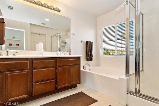 bathroom featuring tile patterned floors, separate shower and tub, and vanity