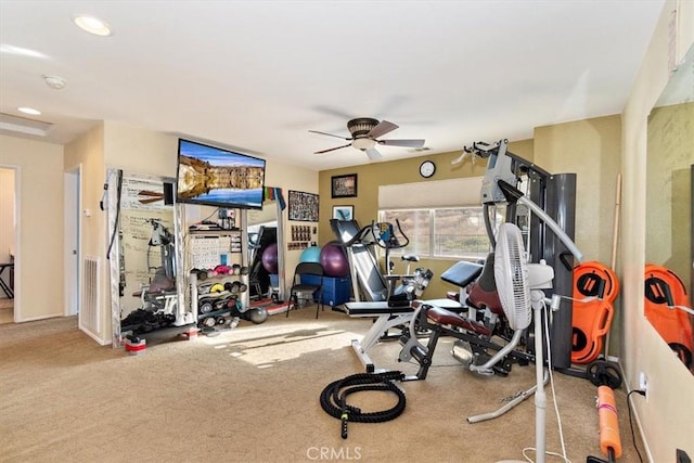 workout area featuring ceiling fan and light colored carpet