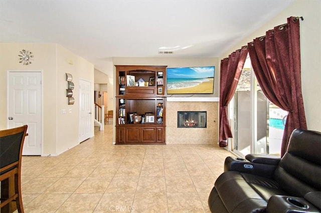 tiled living room featuring a tiled fireplace