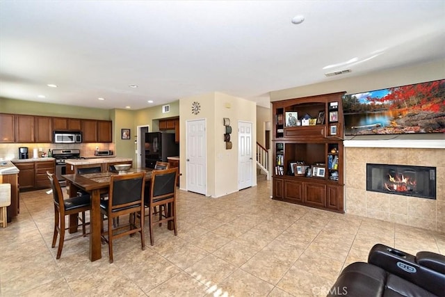 dining area with a tile fireplace