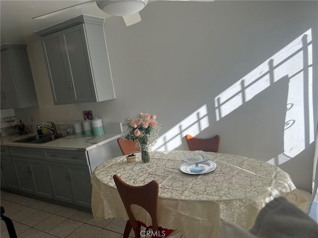 tiled dining room featuring sink