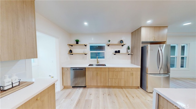 kitchen featuring light hardwood / wood-style floors, sink, stainless steel appliances, and light brown cabinetry