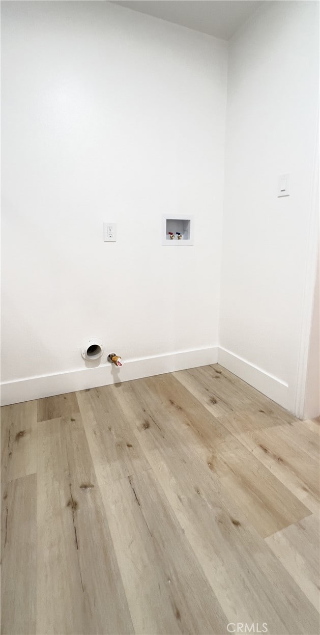 laundry area with hookup for a washing machine, light wood-type flooring, and gas dryer hookup