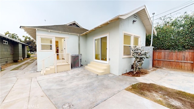 view of front of house with central AC unit and a patio