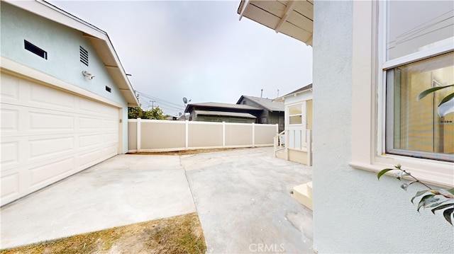 view of patio / terrace featuring a garage