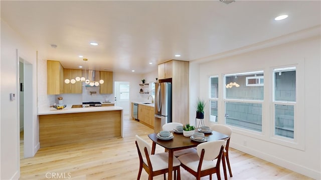 dining room with light hardwood / wood-style flooring and sink