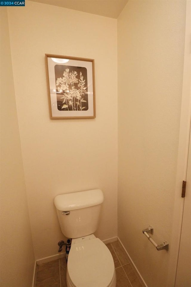 bathroom with tile patterned flooring and toilet