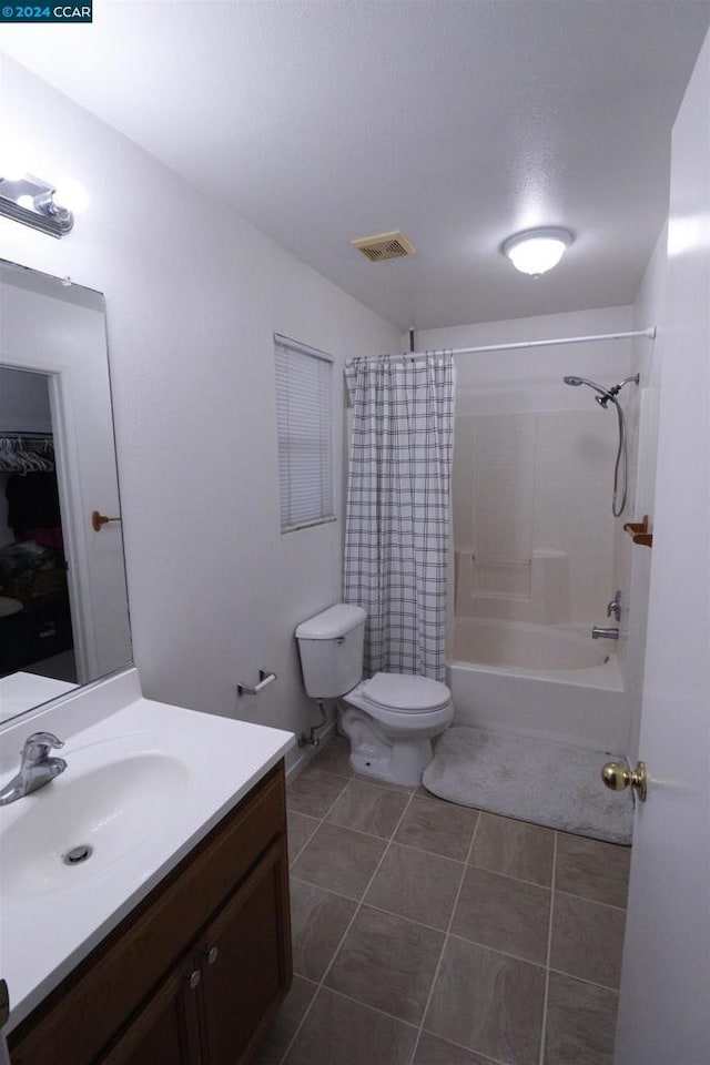 full bathroom featuring tile patterned flooring, vanity, toilet, and shower / tub combo