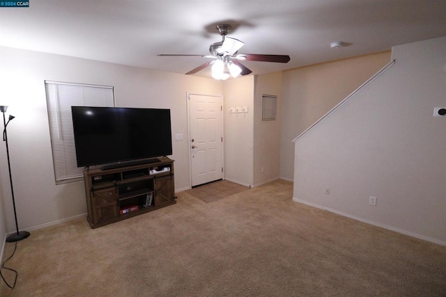 carpeted living room with ceiling fan