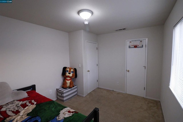 unfurnished bedroom featuring light colored carpet