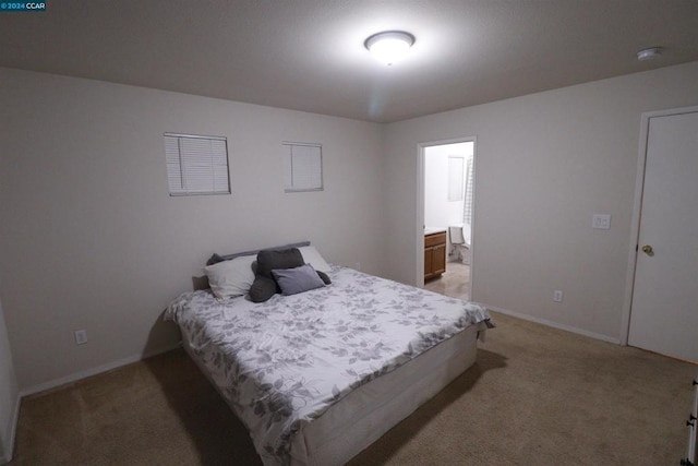 carpeted bedroom with ensuite bath