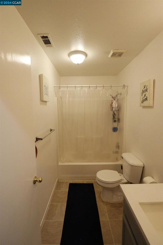 full bathroom featuring tile patterned flooring, vanity, shower / tub combo with curtain, and toilet