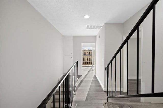 stairway with hardwood / wood-style floors