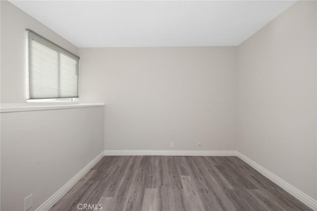 spare room with dark hardwood / wood-style floors