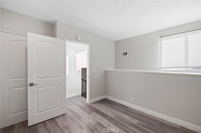 unfurnished room featuring light wood-type flooring