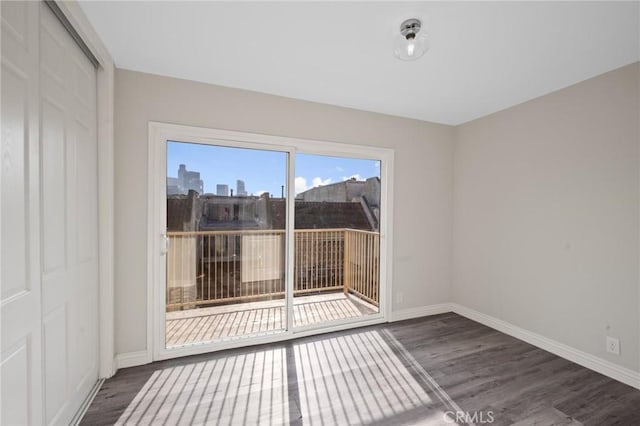 spare room with dark wood-type flooring