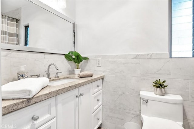 bathroom featuring toilet and tile walls